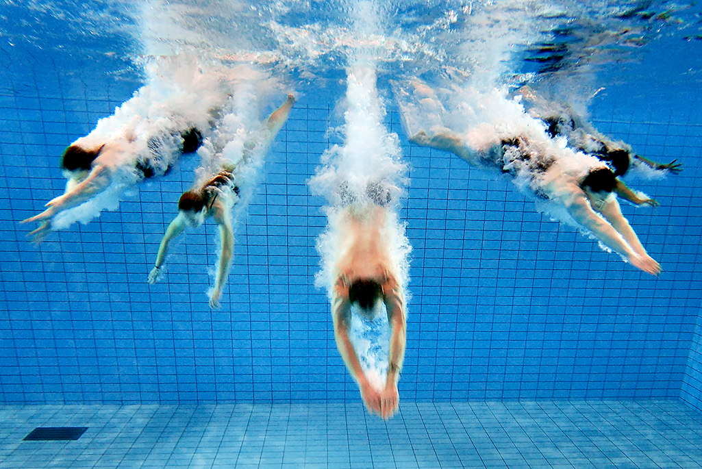 Foto på personer som dyker ner i en pool. Foto: Per Groth